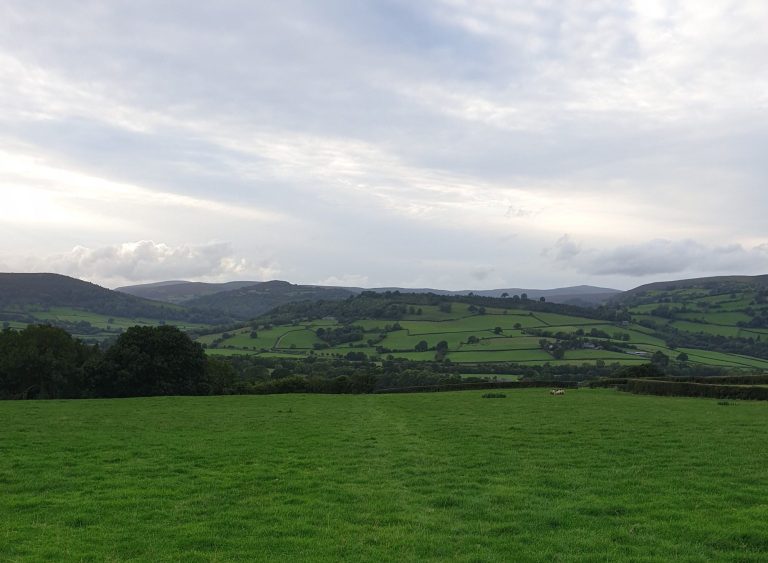 Looking over green fields towards Pandy on the Offa's Dyke