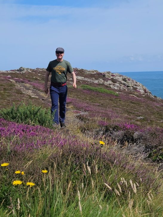 Walking through flowers on coast path