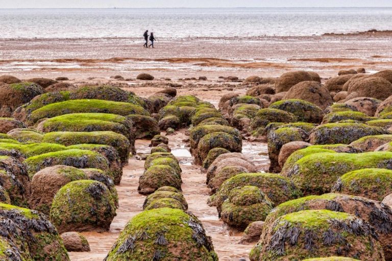 Two people walking along the beach at Hunstanton