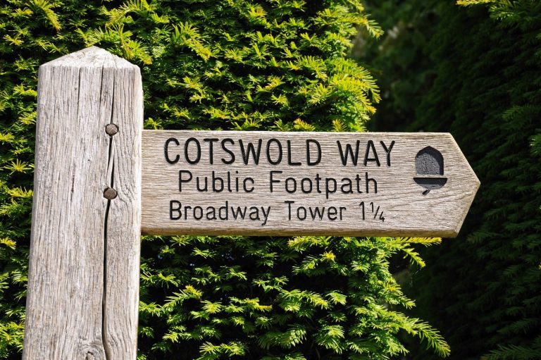 Cotswold wooden sign pointing to Broadway