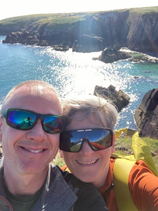 Walkers smiling over coast path