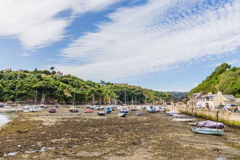 Fishing Harbour in Fishguard, with low tide and people on the Quay