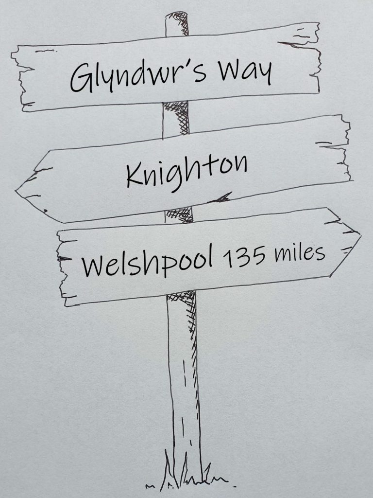 Hand drawn sign post showing Glyndwr's Way, Knighton to Welshpool 135 miles 